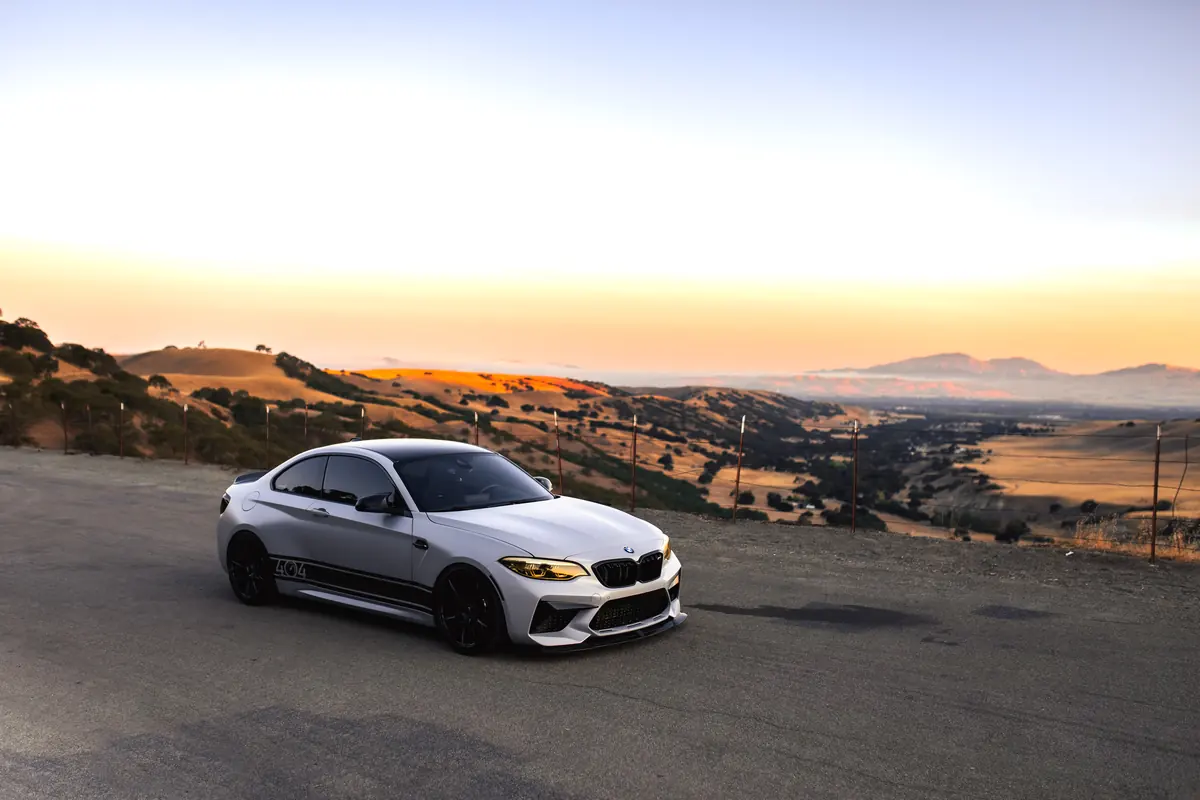 White BMW M2 Competition at sunset